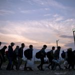 Migrants and refugees queue at a camp to be register after crossing the Macedonian-Greek border near Gevgelija on September 22, 2015. More than 300,000 migrants have arrived by sea in Greece since January, the majority of whom continue their journey through Macedonia and Serbia on their way to EU countries Hungary and Croatia. AFP PHOTO / NIKOLAY DOYCHINOV